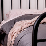 blush pink sheets with slate quilt and blush throw